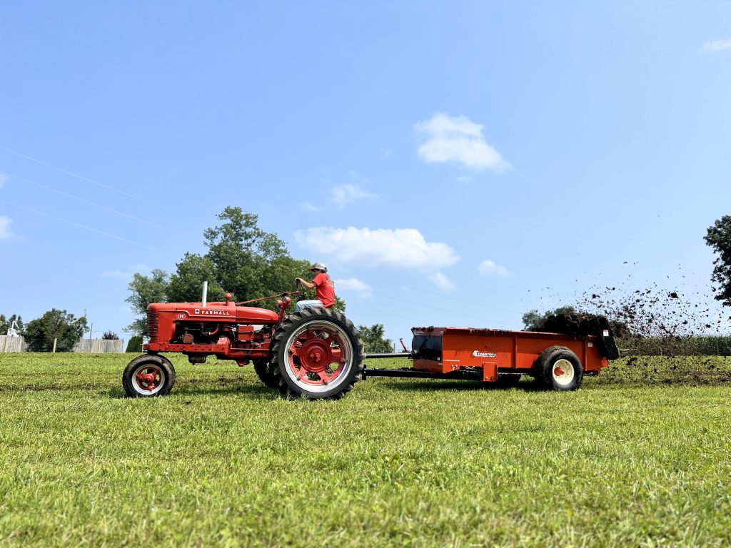 c 125 being pulled by a farmall