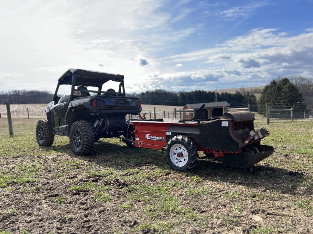 pulling small manure spreader for pasture management